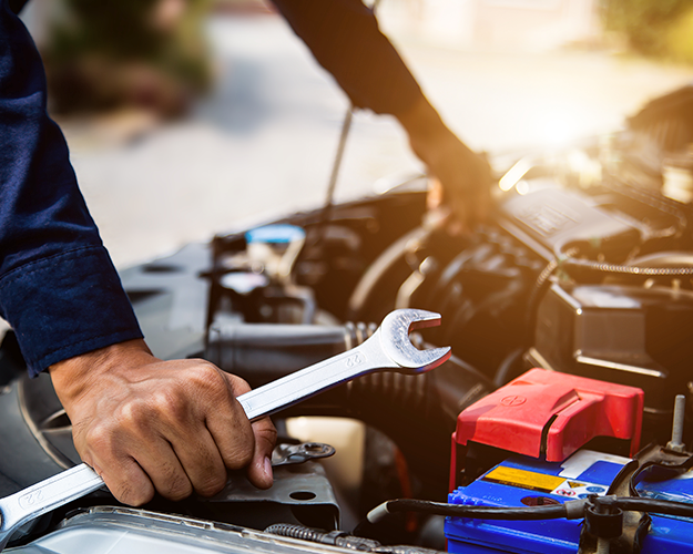 Mechanic repairing car engine bay