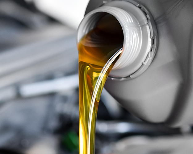 Motor oil pouring into engine