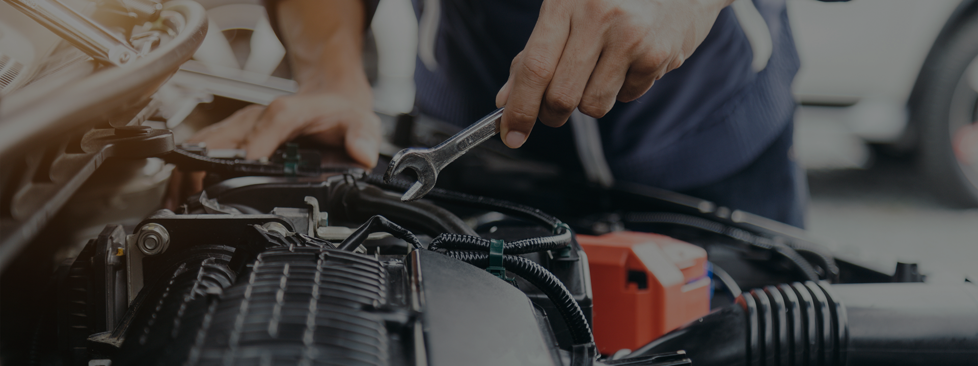 Mechanic repairing car engine bay